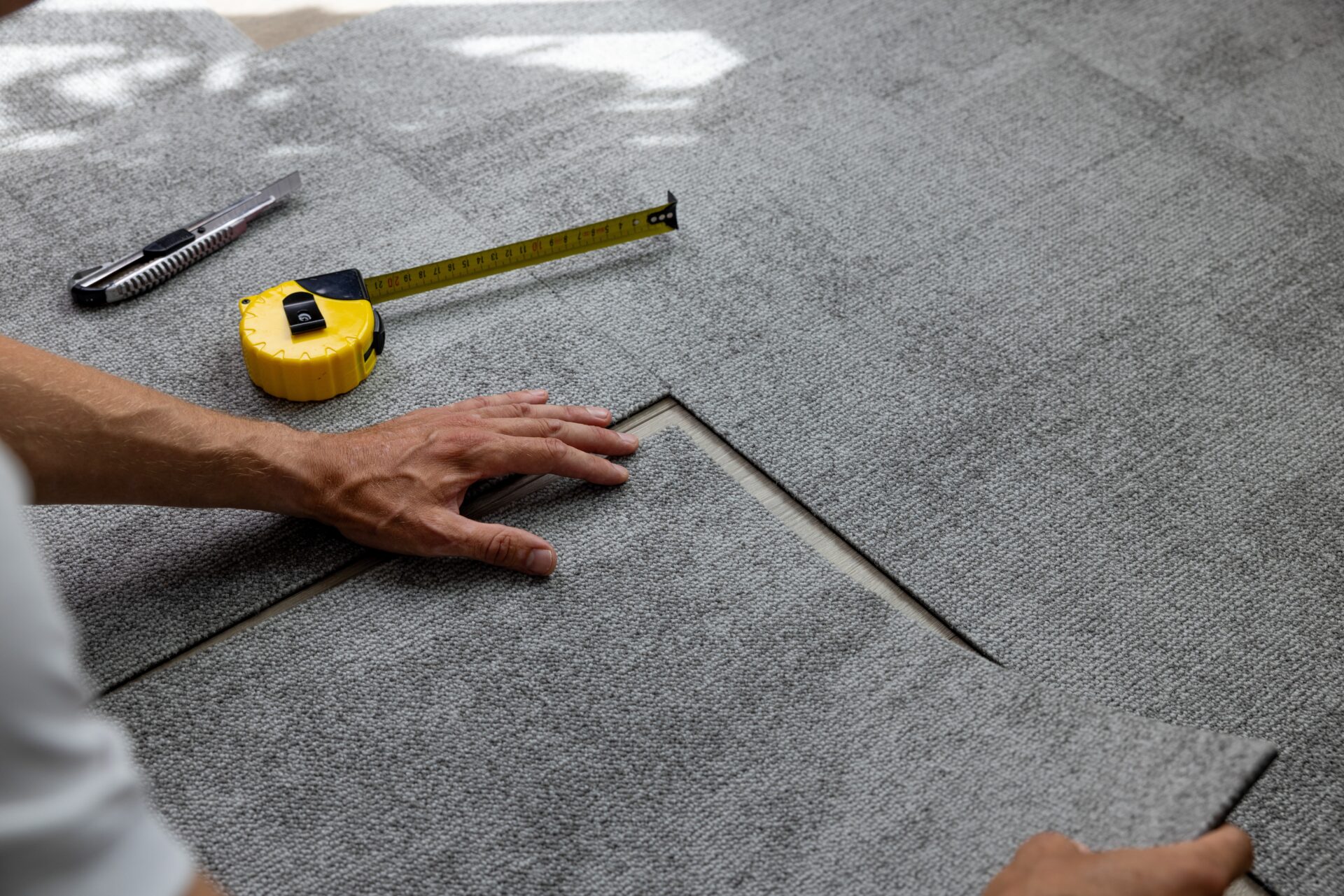 Worker,Installing,Carpet,Tiles,On,The,Floor